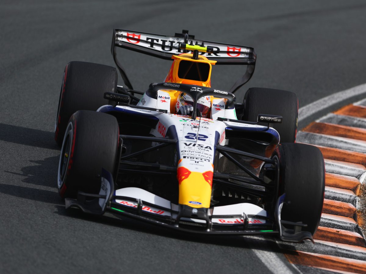 Visa Cash App Racing Bulls Formula 1 car in the garage surrounded by team mechanics ahead of the Italian Grand Prix.