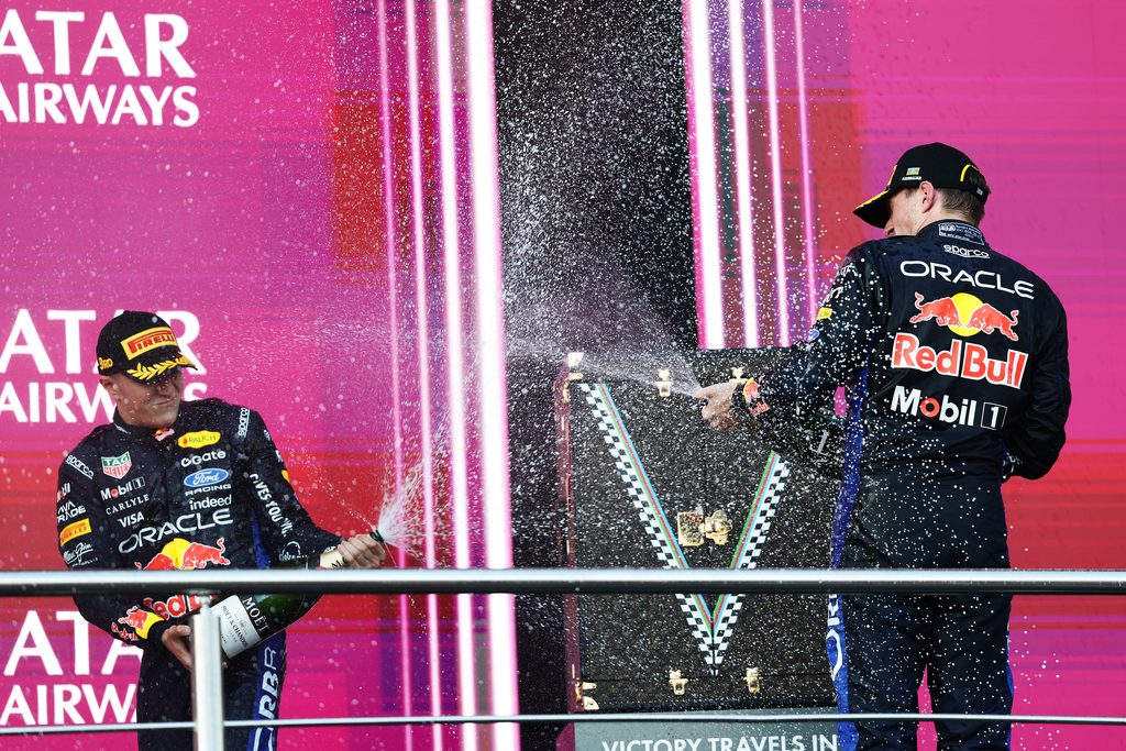 BAKU, AZERBAIJAN - SEPTEMBER 26: Second placed Max Verstappen of the Netherlands and Oracle Red Bull Racing and Third placed Isack Hadjar of France and Oracle Red Bull Racing celebrate with Champagne on the podium during the F1 Grand Prix of Azerbaijan at Baku City Circuit on September 26, 2026 in Baku, Azerbaijan. (Photo by Mark Thompson/Getty Images) // Getty Images / Red Bull Content Pool // SI202609260268 // Usage for editorial use only //
