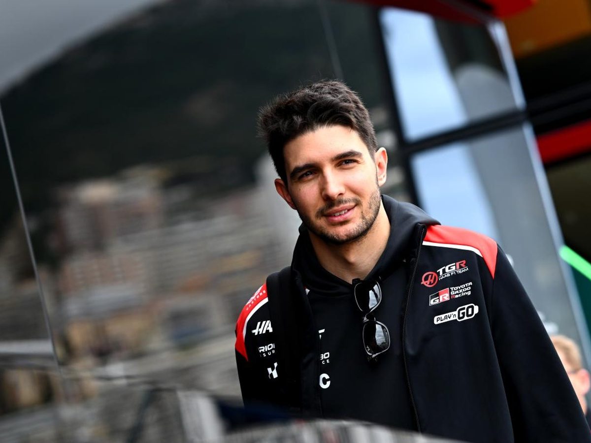 Esteban Ocon wearing TGR Haas F1 Team clothing in the Formula 1 paddock.